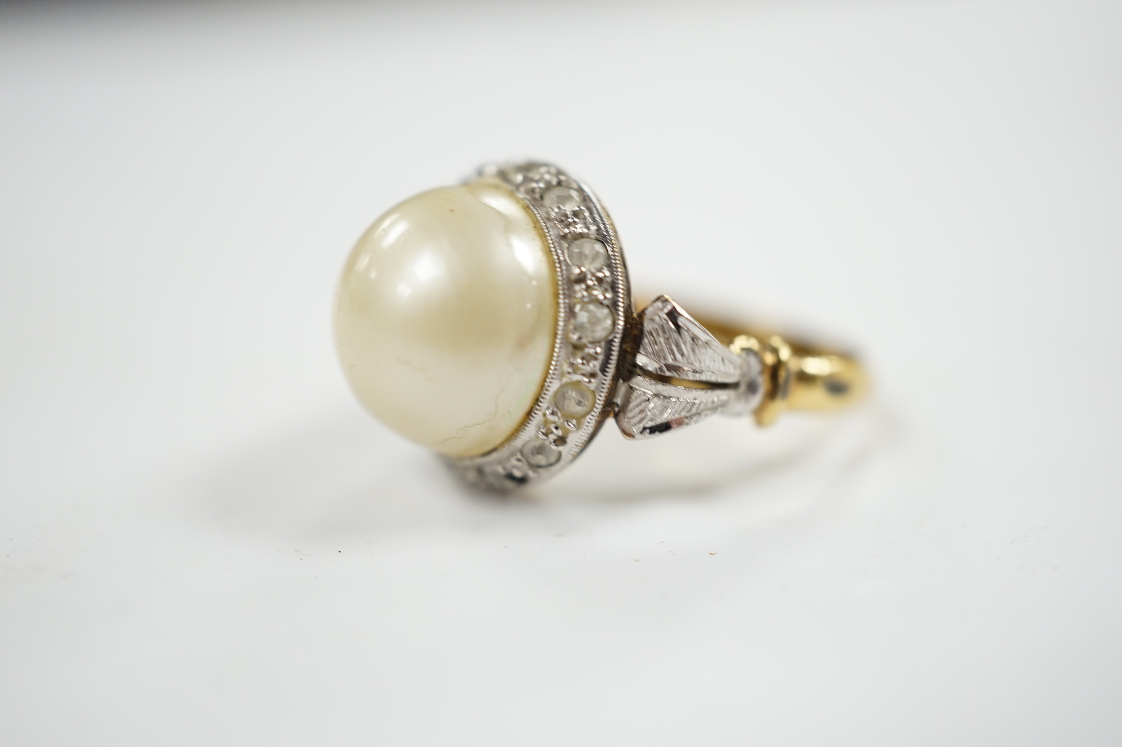 A yellow metal, simulated mabe pearl and paste set cluster ring, size O, gross weight 4.6 grams.